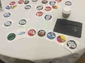 Image of logos of all of the FinCon conferences on a meetup table along with Doug's keyboard and coffee cup. | The-Military-Guide.com