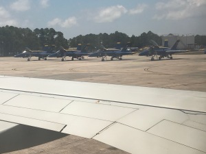 Image of Navy Blue Angels F/A-18 Hornet aircraft at Naval Air Station Pensacola, with the wing of our C-40 passenger jet in foreground. | The-Military-Guide.com